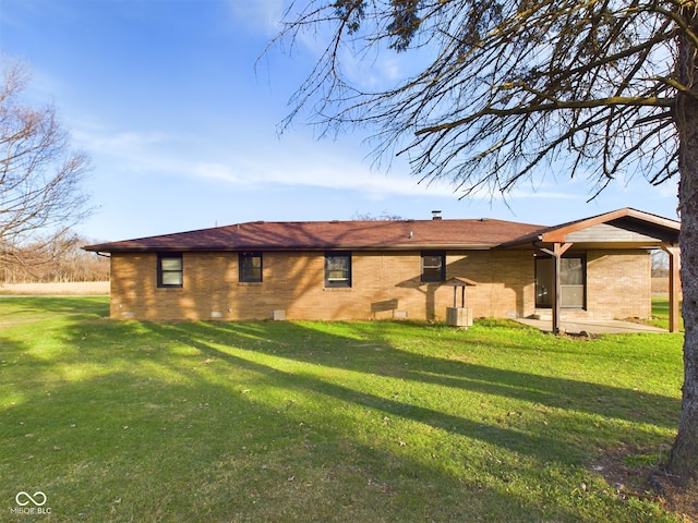 back of house featuring a patio and a yard