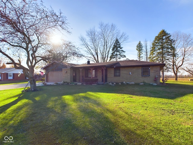 ranch-style home with a garage and a front yard