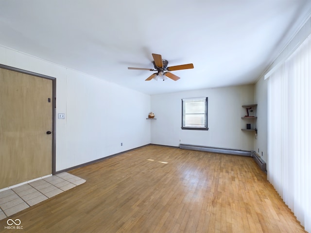 spare room with light hardwood / wood-style floors, ceiling fan, and a baseboard radiator