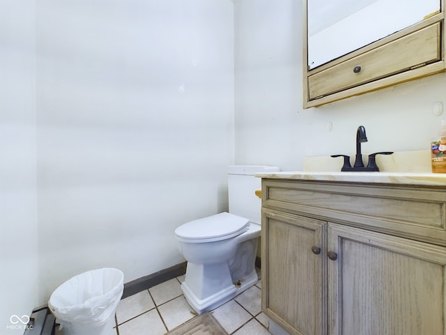 bathroom featuring tile patterned flooring, vanity, and toilet