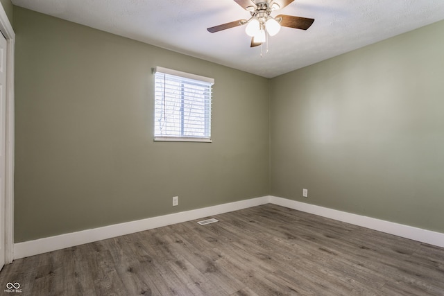 empty room featuring ceiling fan and hardwood / wood-style floors