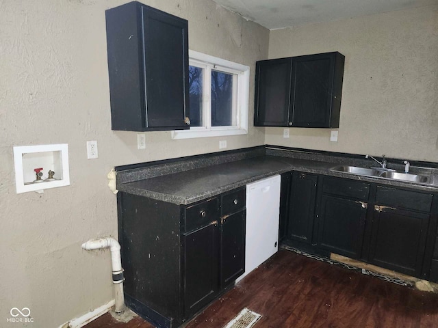 kitchen with dishwasher, sink, and dark hardwood / wood-style floors