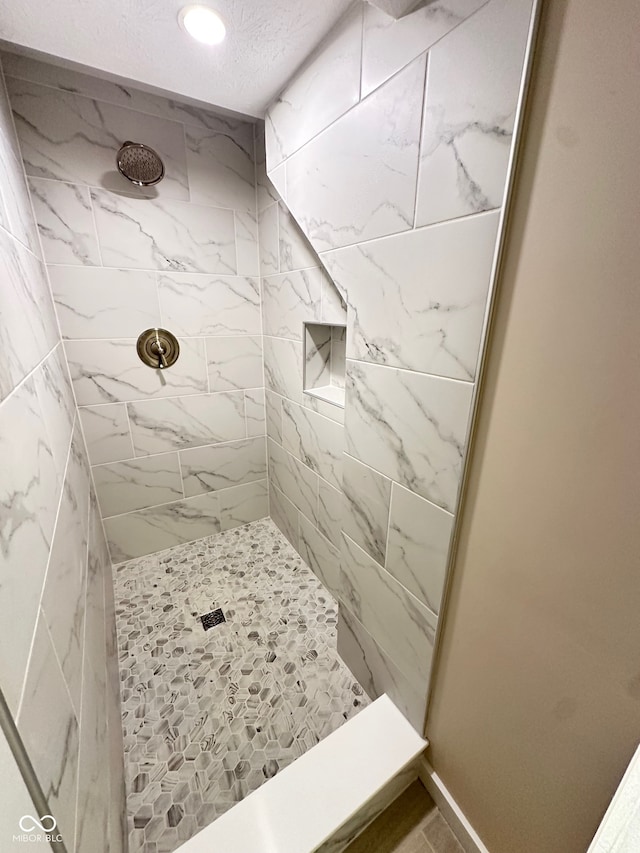 bathroom with a tile shower