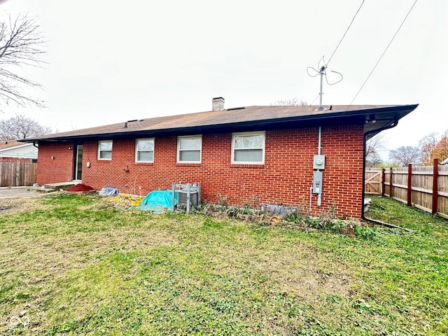 back of house with a yard