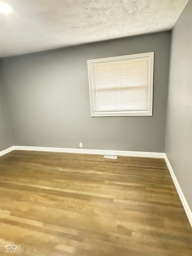 unfurnished room featuring wood-type flooring