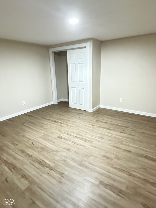 unfurnished bedroom with a closet and hardwood / wood-style flooring