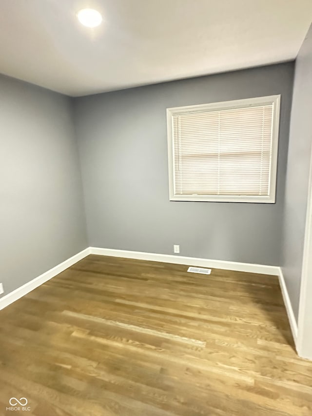 unfurnished room with hardwood / wood-style floors