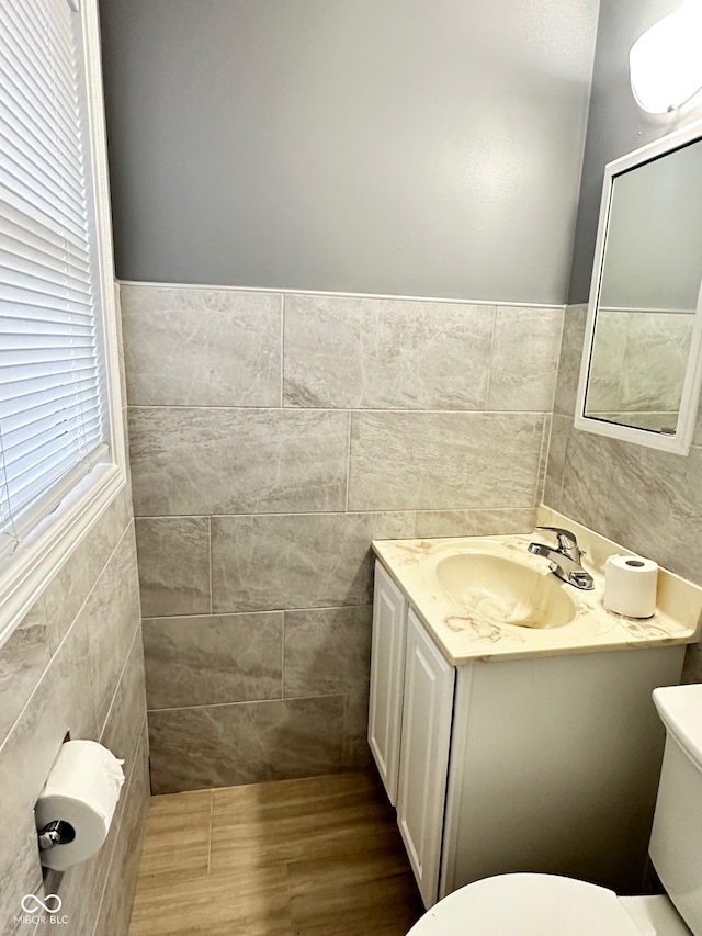 bathroom featuring vanity and tile walls