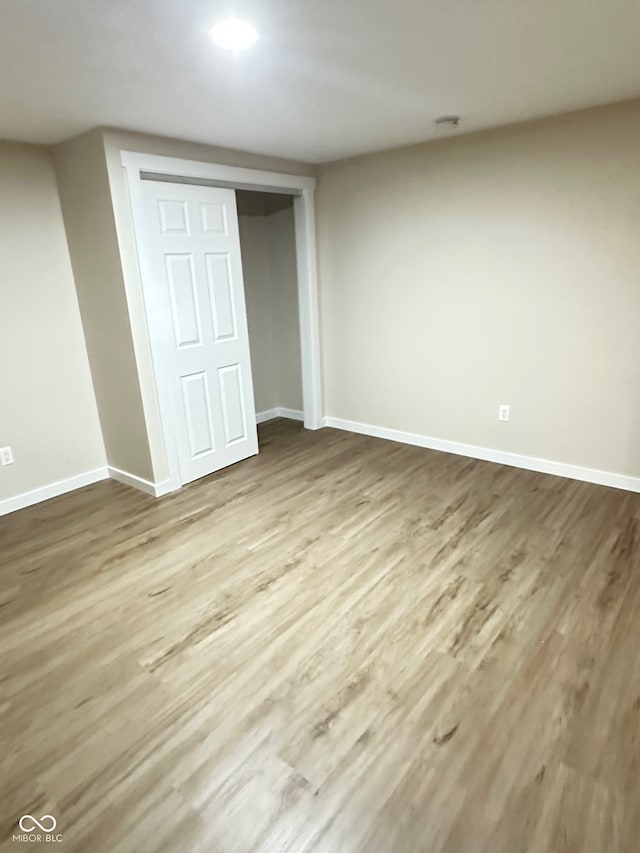 unfurnished bedroom with light hardwood / wood-style floors and a closet