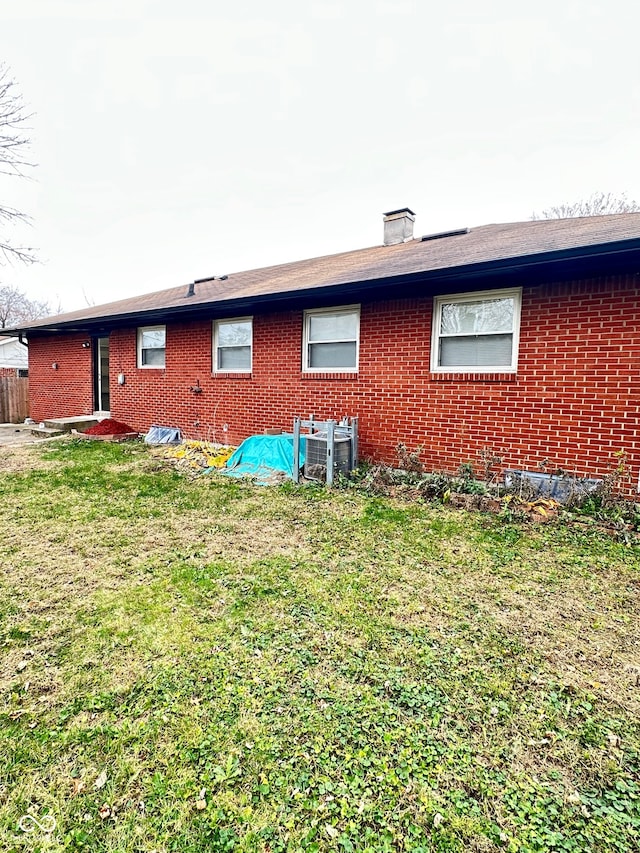 rear view of house featuring a lawn