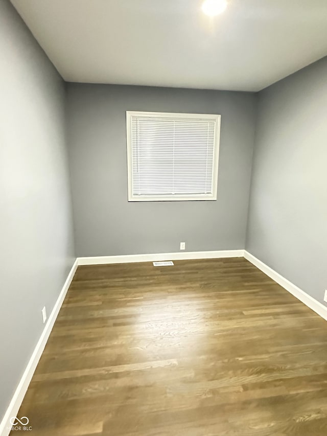 spare room with hardwood / wood-style floors