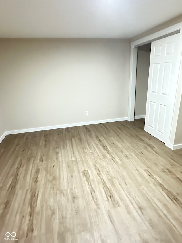 unfurnished bedroom featuring wood-type flooring and a closet