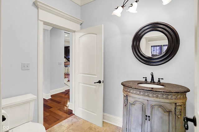 bathroom featuring toilet, vanity, and tile patterned floors