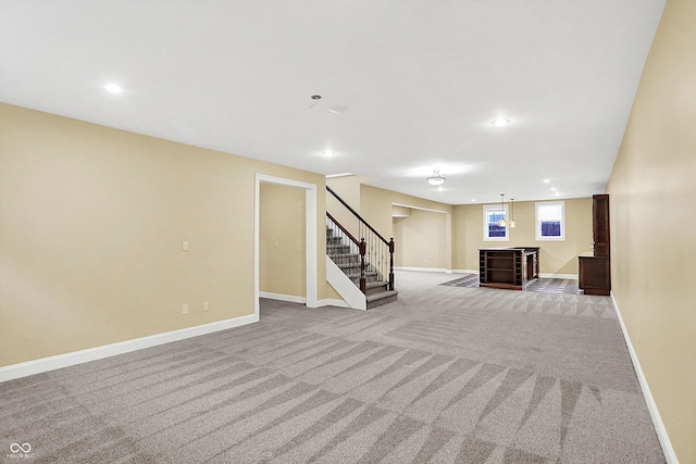 basement with light carpet and bar area