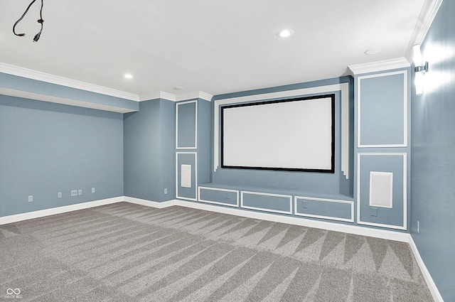 carpeted home theater room featuring ornamental molding