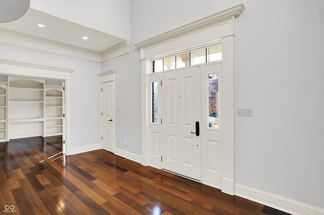 entryway with dark hardwood / wood-style flooring and ornamental molding