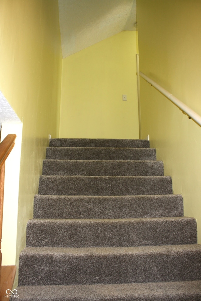 stairs with vaulted ceiling