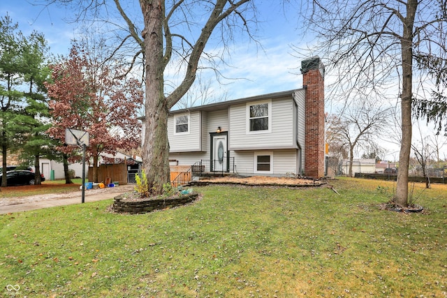 raised ranch featuring a front yard