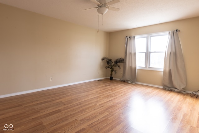 spare room featuring ceiling fan, a textured ceiling, and light hardwood / wood-style flooring