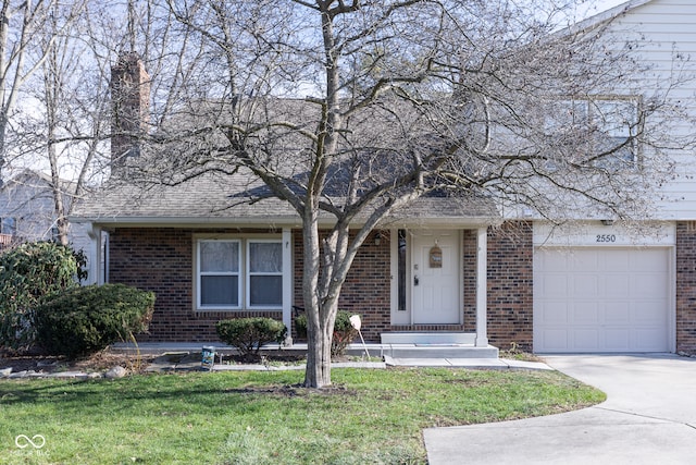 view of front of home with a front yard and a garage