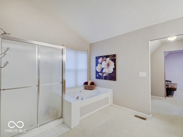 bathroom with a textured ceiling, shower with separate bathtub, and vaulted ceiling