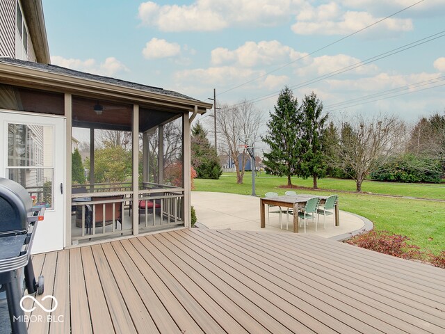 wooden terrace featuring a lawn, a patio area, a sunroom, and a grill