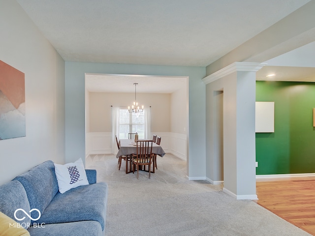 carpeted dining area with a notable chandelier