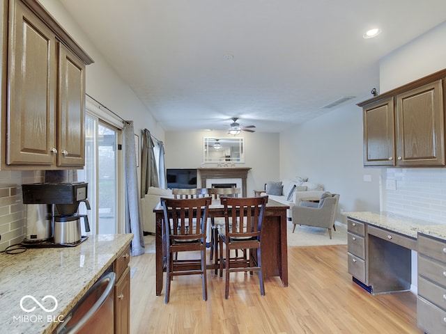 dining area with ceiling fan and light hardwood / wood-style floors