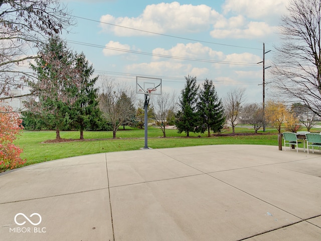 view of sport court with a lawn