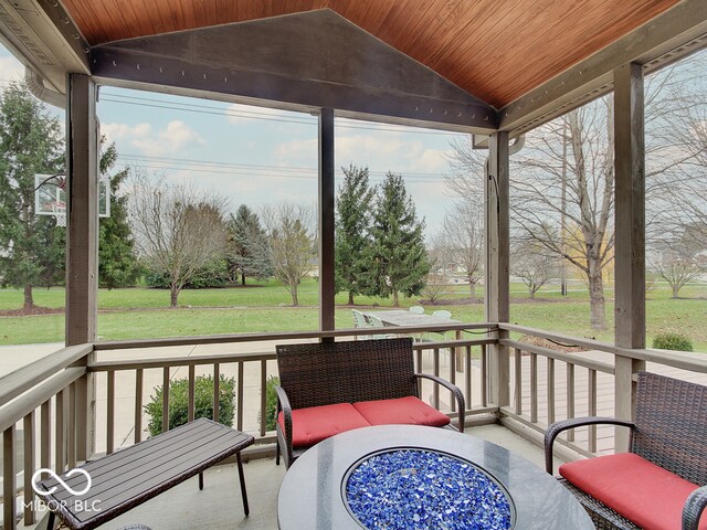 sunroom with lofted ceiling and wooden ceiling