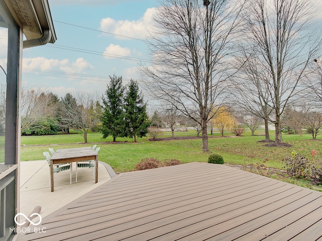 wooden deck with a patio and a lawn