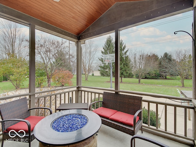 sunroom with lofted ceiling, wood ceiling, and a wealth of natural light