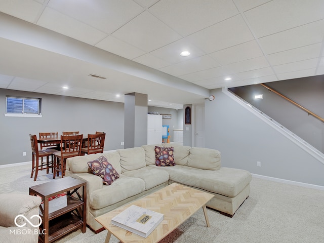 living room with carpet and a drop ceiling