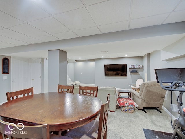 dining room featuring a drop ceiling and carpet floors