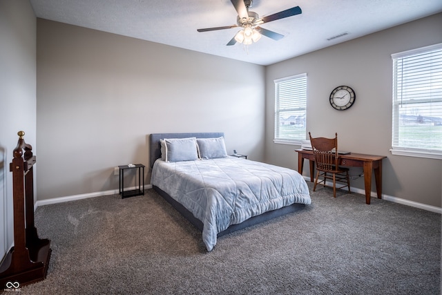 carpeted bedroom with ceiling fan and a textured ceiling