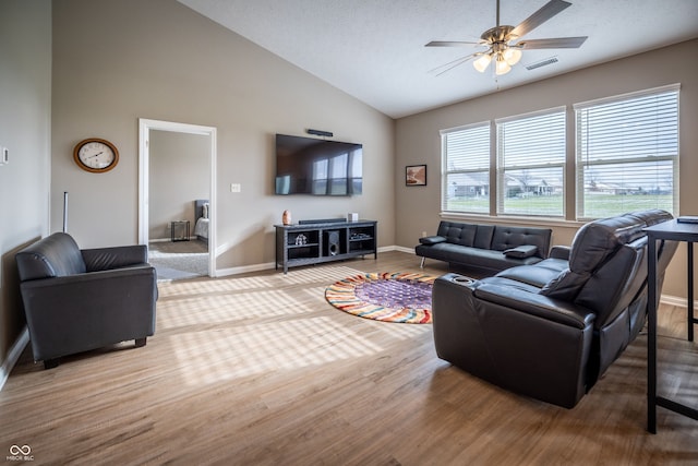 living room featuring a textured ceiling, hardwood / wood-style flooring, high vaulted ceiling, and ceiling fan