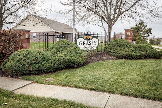 community / neighborhood sign with a lawn