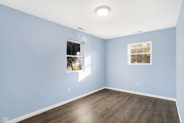 empty room with dark wood-type flooring