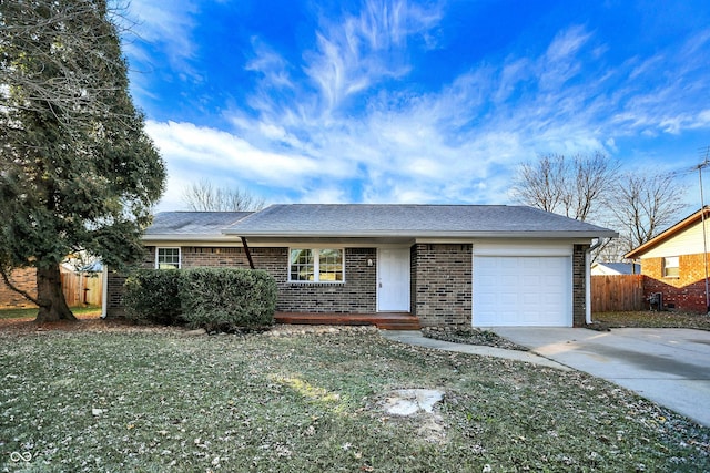 ranch-style home featuring a garage and a front lawn