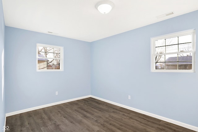 empty room with dark hardwood / wood-style floors