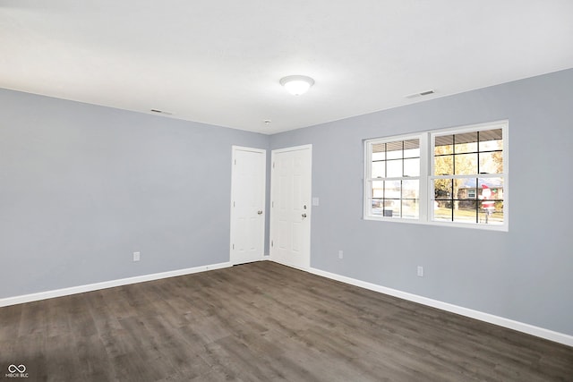 unfurnished room with dark hardwood / wood-style floors