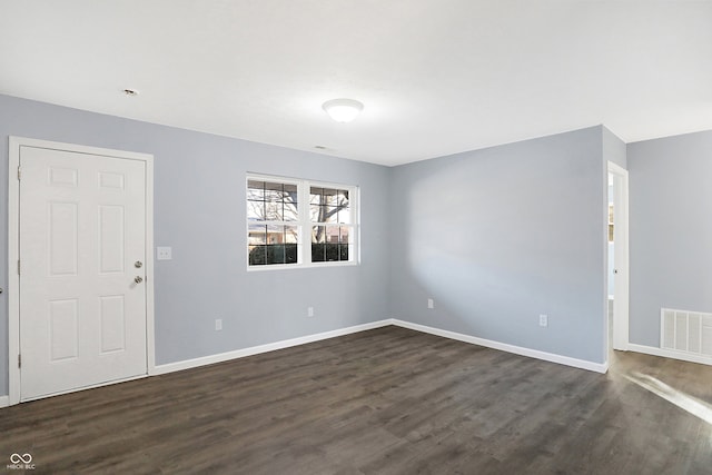 unfurnished room with dark hardwood / wood-style flooring