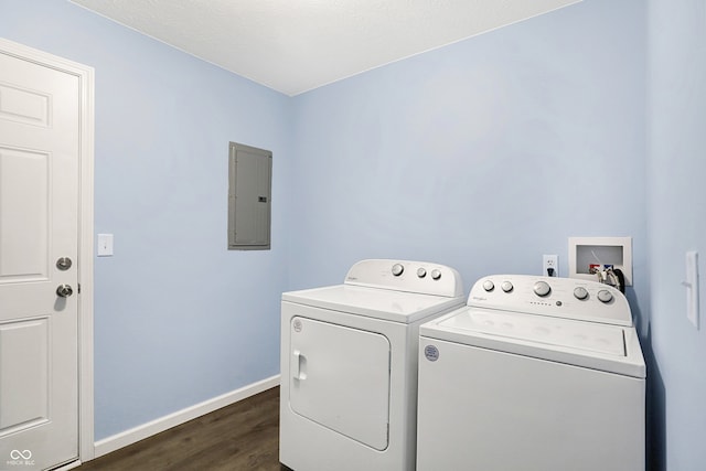 clothes washing area with washing machine and clothes dryer, electric panel, and dark wood-type flooring