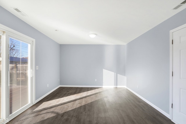 spare room with dark hardwood / wood-style floors