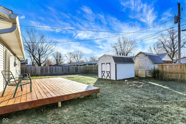 view of yard featuring a shed and a wooden deck