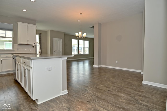 17345 Northam Dr, Westfield, IN 46074 - kitchen with a kitchen island with sink, a sink, dark wood-style flooring, open floor plan, and a notable chandelier