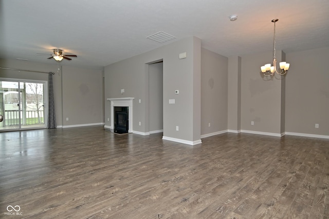 17345 Northam Dr, Westfield, IN 46074 - unfurnished living room with ceiling fan with notable chandelier, a glass covered fireplace, baseboards, dark wood-type flooring, and visible vents