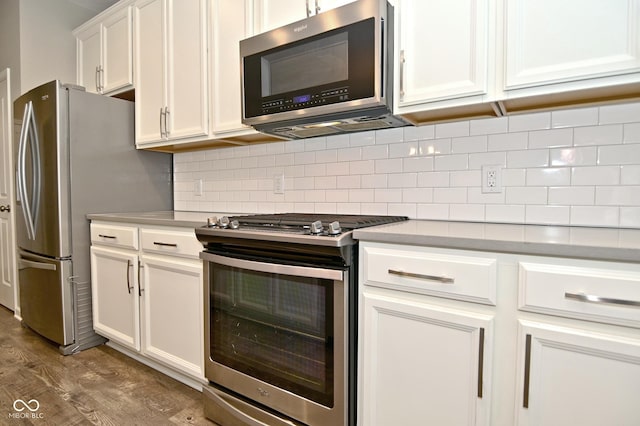 17345 Northam Dr, Westfield, IN 46074 - kitchen featuring stainless steel appliances, light countertops, wood finished floors, and white cabinetry