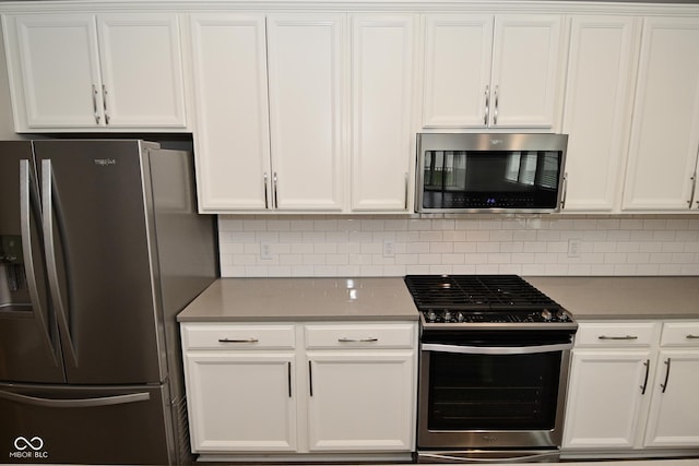 17345 Northam Dr, Westfield, IN 46074 - kitchen with white cabinets, backsplash, and appliances with stainless steel finishes