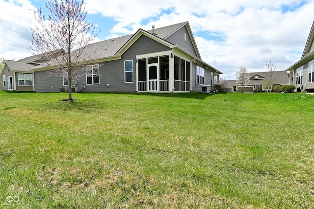 17345 Northam Dr, Westfield, IN 46074 - rear view of property with a sunroom, a yard, and central AC unit